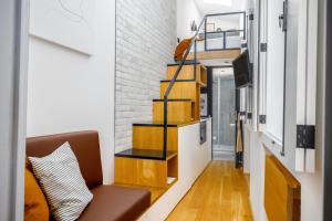 ein Wohnzimmer mit einer Treppe und einer Couch in der Unterkunft Saudade Micro Loft - Santos in Lissabon