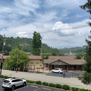 a street with cars parked in front of a building at Olde Gatlinburg Rentals in Gatlinburg