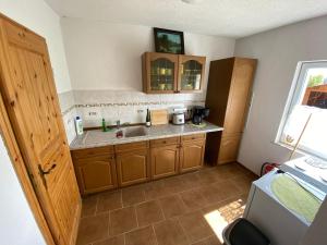 a small kitchen with a sink and a window at Ferienhaus Gutedel in Freyburg +10 photos