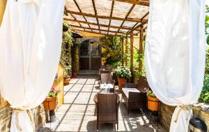 eine Terrasse mit Korbstühlen und einer Pergola in der Unterkunft Casale San Martino in Laureana Cilento