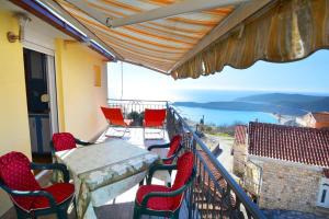 a balcony with a table and chairs and a view at MARINOVIC APARTMENTS in Budva +11 photos