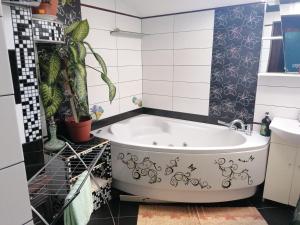 a bathroom with a tub and a sink at Plata iela Ventspils center apartment in Ventspils