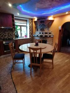 a kitchen with a table and chairs and a fireplace at Plata iela Ventspils center apartment in Ventspils