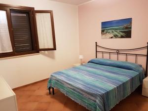 a bedroom with a bed and a window at Trilocale Maestrale in Favignana +20 photos