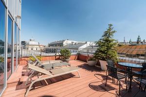 a balcony with chairs and tables on a building at Aparthotel Best Views in Krakow +103 photos