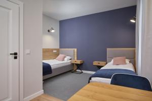 Posteľ alebo postele v izbe v ubytovaní Apartamenty Queen