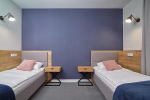 Posteľ alebo postele v izbe v ubytovaní Apartamenty Queen