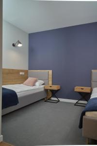 Posteľ alebo postele v izbe v ubytovaní Apartamenty Queen