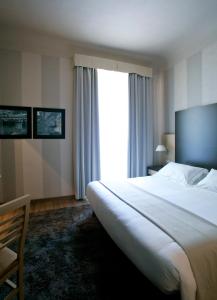 a hotel room with a large bed and a window at c-hotels Club in Florence