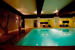 a large swimming pool in a hotel room at Hotel Clermont in Covasna