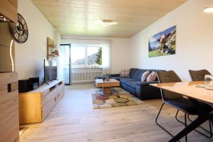 a living room with a couch and a table at Scheiblesmoos 4 Sterne in Nesselwang