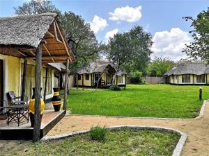 a group of cottages with a grass yard at Africa Safari Selous Nyerere national park in Nyakisiku