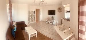 a living room with a couch and a table at Sun7 view Montpellier, Piscine, Parking GRATUIT in Grabels