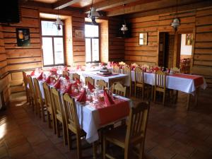 a dining room with tables and chairs with red napkins at Hotel Kreta in Kutná Hora