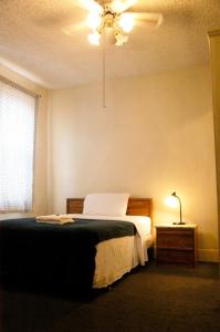 a bedroom with a bed and a lamp on a table at Little Tokyo Hotel in Los Angeles