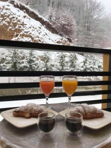 due bicchieri di vino e pasticcini su un tavolo di Mavrovo Twins Apartment a Mavrovo