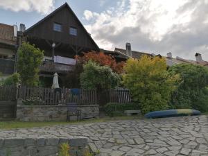 a house with a wooden fence and a blue raft at Guest House Olšakovský in Český Krumlov
