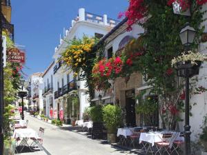 a city street filled with lots of flowers at Puerta De Aduares in Marbella