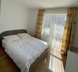 a bedroom with a bed and a large window at Pokoje u Jarka in Krzyżowa