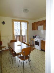 a kitchen with a wooden table and chairs and a kitchen with a stove at Pic de la Corne in Abondance