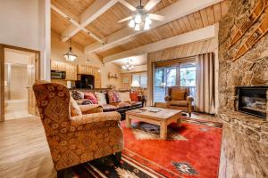 a living room with a couch and a fireplace at Phoenix III in Steamboat Springs