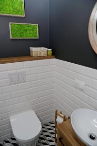 a bathroom with a white toilet and a sink at Chill&Sun Yellow in Łukęcin