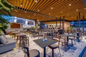 - un restaurant avec des tables et des chaises dans une salle dans l'établissement Sellada Beach, à Perissa