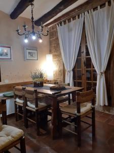 a dining room with a wooden table and chairs at Lo Cremallé in Valderrobres