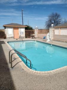 a large swimming pool with a curved rail around it at Budget Inn San Antonio Downtown I-10 East in San Antonio