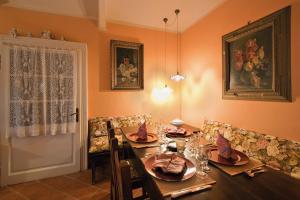 a dining room with a wooden table with chairs and a tableablish at Tenuta Terensano in Monleale