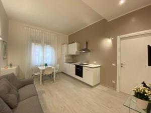 a living room with a couch and a table and a kitchen at Riviera Apartments in Pescara