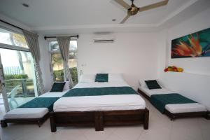 Una cama o camas en una habitación de Hotel Playa Blanca - San Antero