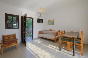 a living room with a table and a couch at Bayview Apartments in Agios Nikolaos