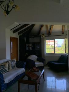 a living room with couches and a coffee table at Villa Riverside in Platána +2 photos