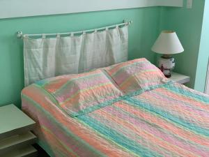 1 dormitorio con 1 cama con un edredón colorido en Studio Copacabana 1003, en Río de Janeiro