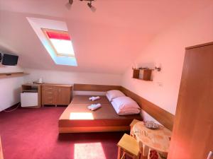 a small bedroom with a bed and a window at Willa Carmen in Krynica Zdrój