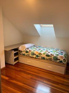 ein kleines Schlafzimmer mit einem Bett und einem Fenster in der Unterkunft Apto Valle Encantado, vistas preciosas en urbanización con piscina in Gibaja