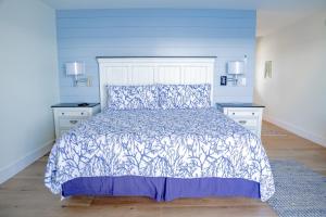 a bed in a room with a white bedspread at Linekin Bay Resort in Boothbay Harbor
