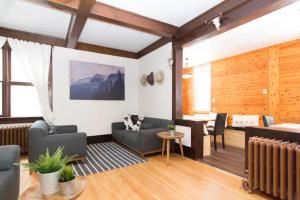 a living room with two couches and a table at Banff's Rocky Mountain House in Banff