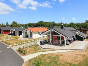 a home with a large deck and a house at Three-Bedroom Holiday home in Grömitz 13 in Grömitz