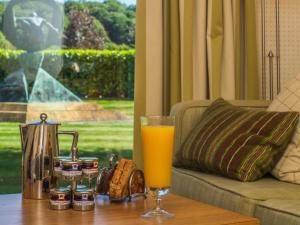 a glass of orange juice sitting on a table at Donnington Valley Hotel, Golf & Spa in Newbury