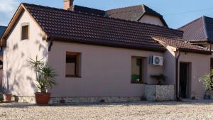 a white house with a black roof at Ivanhoe Apartman in Nyírbátor