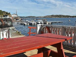 a wooden bench sitting on a dock near the water at 6 person holiday home in Oksvoll in Oksvoll