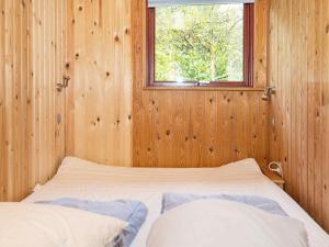 A bed or beds in a room at Four-Bedroom Holiday home in Skanderborg