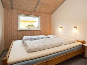 a bed in a room with a window at 8 person holiday home in Stege in Stege