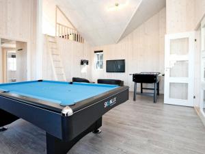a billiard room with a pool table and a tv at 14 person holiday home in Odder in Odder