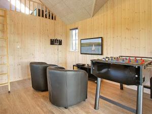 a room with a ping pong table and chairs at 14 person holiday home in Odder in Odder