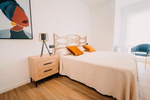 Posteľ alebo postele v izbe v ubytovaní Apartamentos Rúa Vella