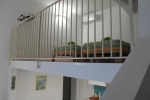 a staircase with two beds in a room at Le case di Carlotta & Giorgia in Pozzillo