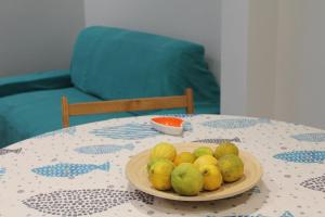 a plate of lemons and pears on a table at Le case di Carlotta & Giorgia in Pozzillo